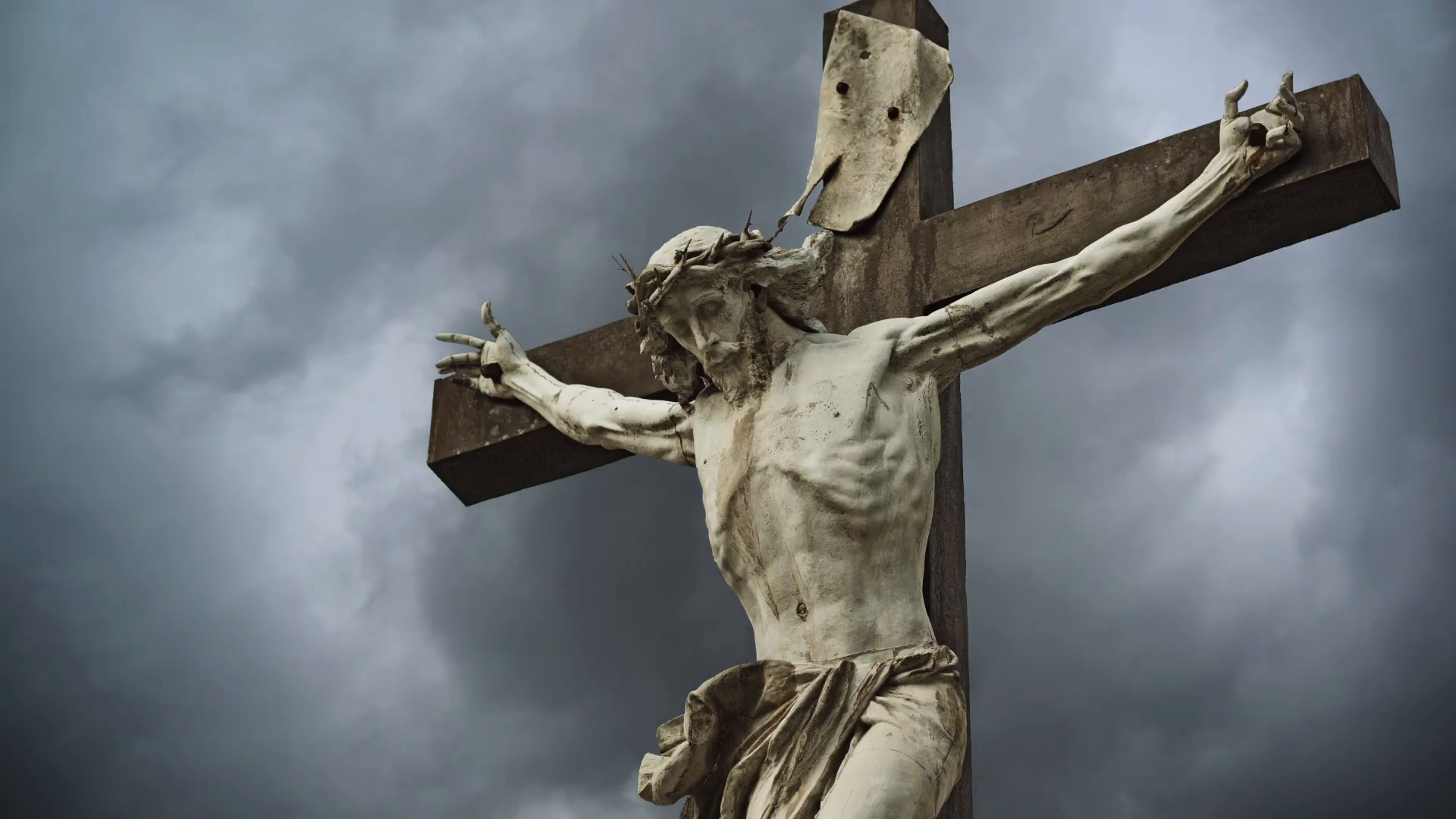 crucifixion-christian-cross-with-jesus-christ-statue-over-stormy-clouds-time-lapse-1920x1080-1080p-hd-format_myujbof8__F0000